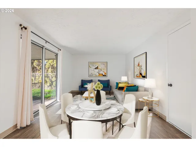 a living room with furniture a window and dining table