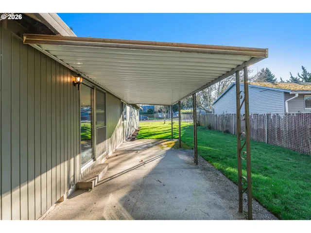 a view of an house with backyard space and balcony