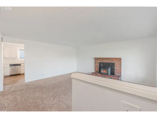 a view of an empty room and fire place