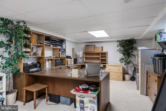 a open kitchen with stainless steel appliances kitchen island granite countertop a sink dishwasher and a refrigerator with wooden cabinets