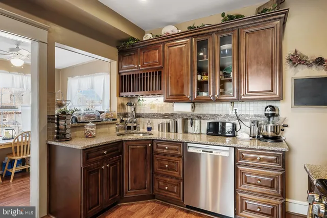 a kitchen with stainless steel appliances granite countertop a sink stove and cabinets