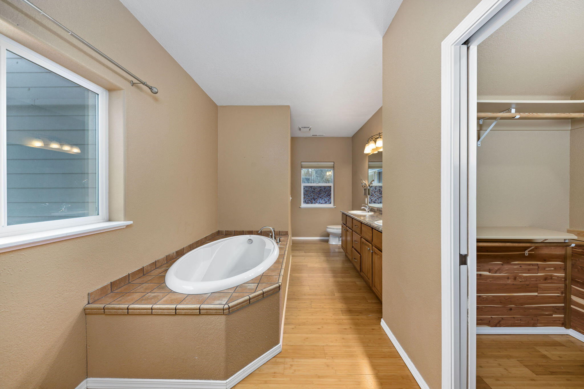 10523 Lower River Road Grants Pass, OR 97526 - Photo 20 of 58 Primary bathroom with large walk-in closet, soaking tub, and separate shower.