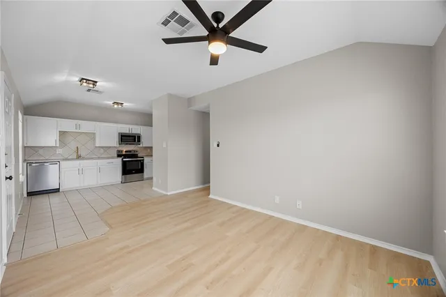 a view of kitchen with wooden floor and window