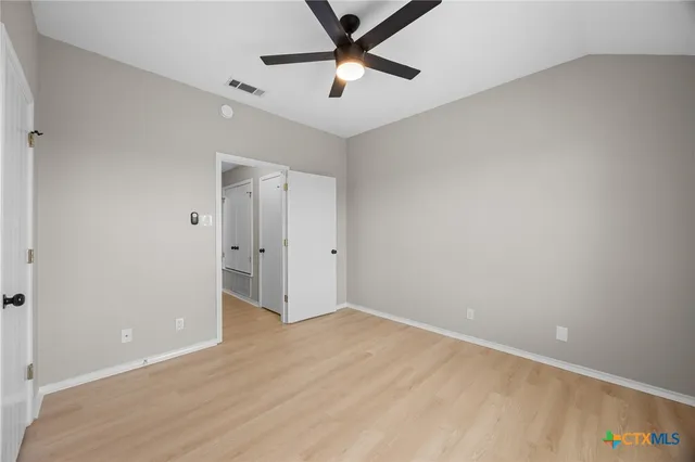 a bathroom with a granite countertop sink a toilet and mirror