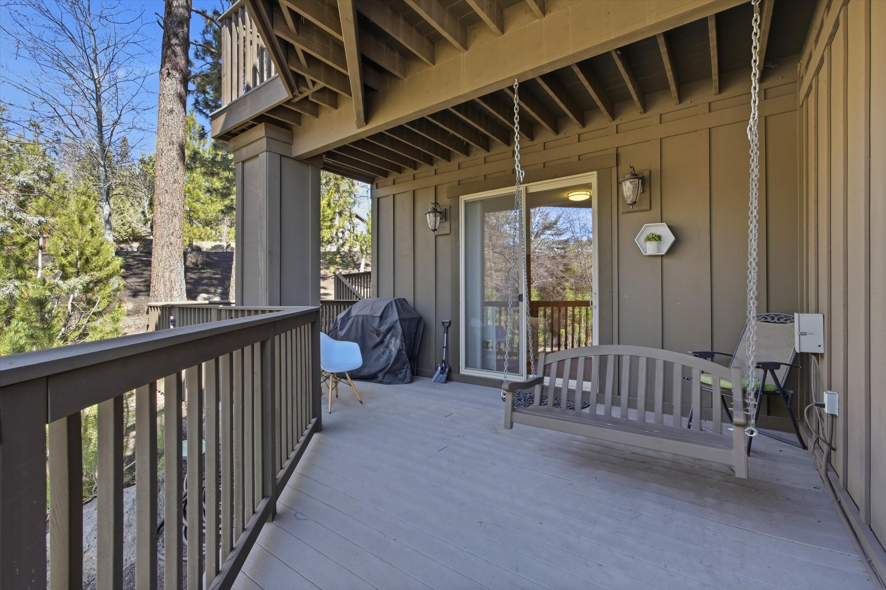 15 Southwest Quail Butte Place Bend, OR 97703 - Photo 49 of 55 a view of a porch with wooden floor and windows