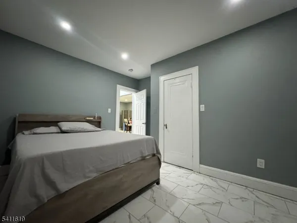 a room with a bed and lamp