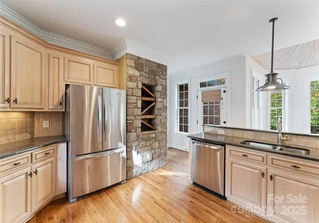 a kitchen with stainless steel appliances a refrigerator and a sink