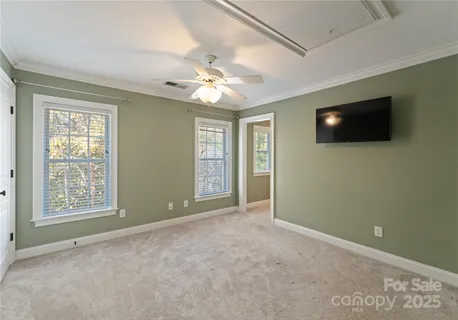 a view of an empty room with a window and a flat screen tv