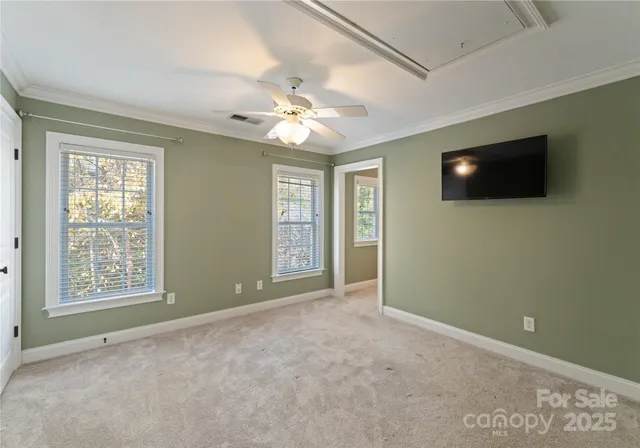 a view of an empty room with a window and a flat screen tv