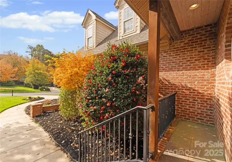 a view of a pathway with a wrought iron fence