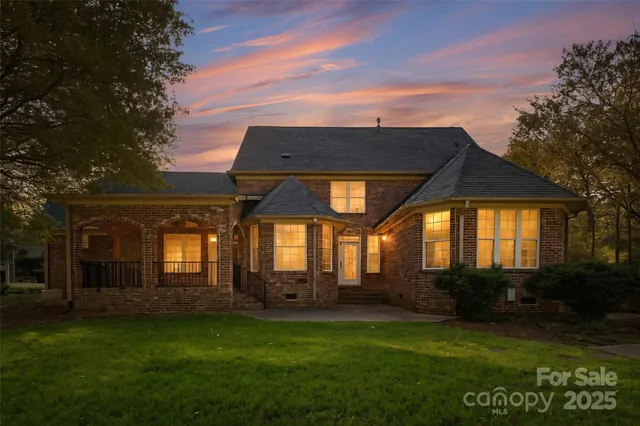 a front view of house with yard and green space