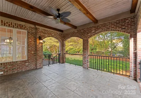 a view of a porch with a table and chairs