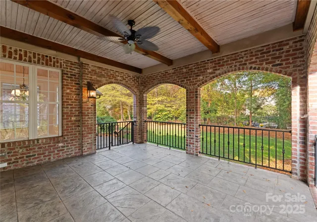 a view of a porch with a table and chairs