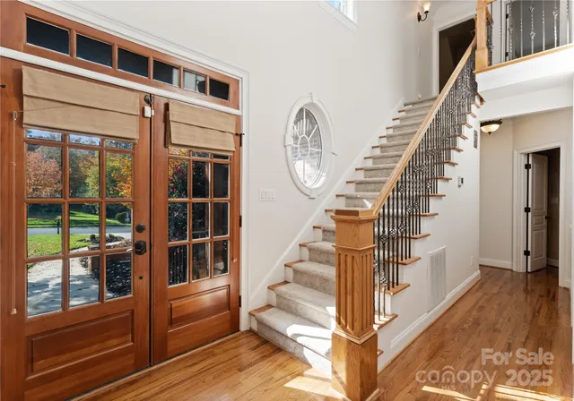 a view of entryway and hall with wooden floor