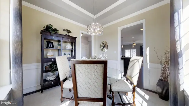 a view of a dining room with furniture and a chandelier
