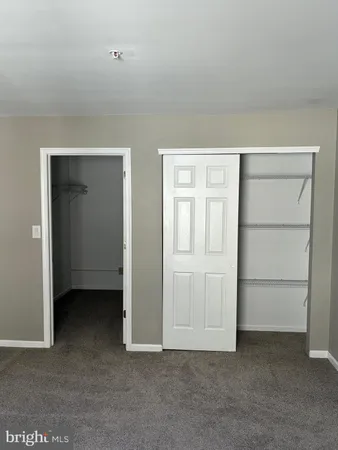 a view of an empty room with closet area