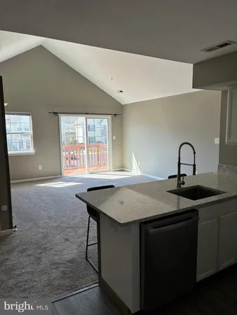 a kitchen with a sink a counter space and a window