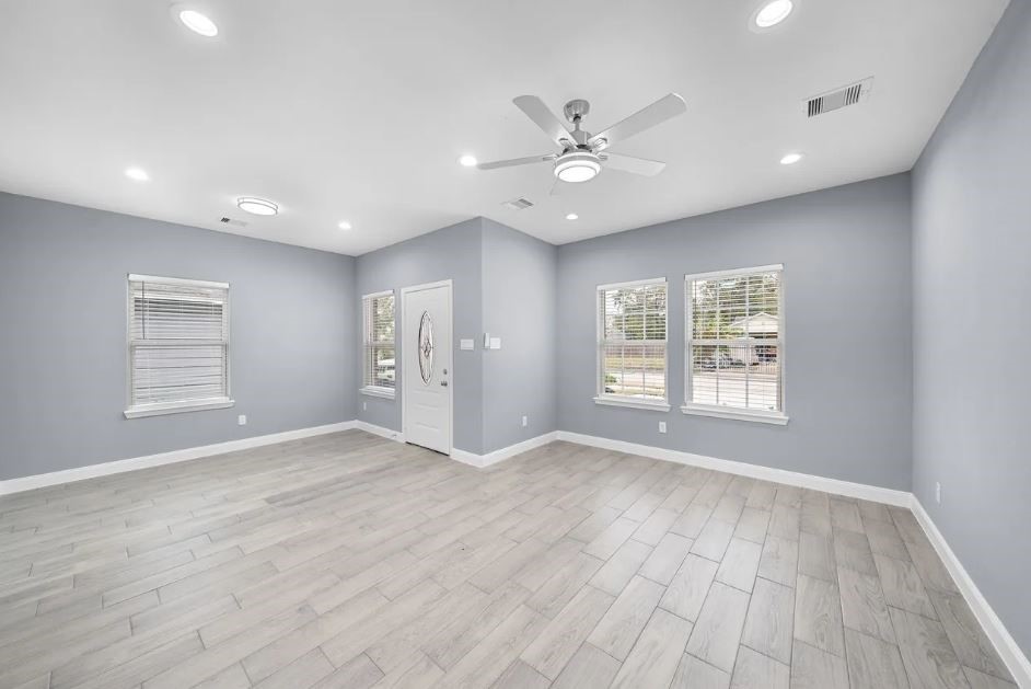 5222 Bataan Road Houston, TX 77033 - Photo 6 of 22 Expansive family room filled with natural light and contemporary charm, perfect for gatherings and relaxation.