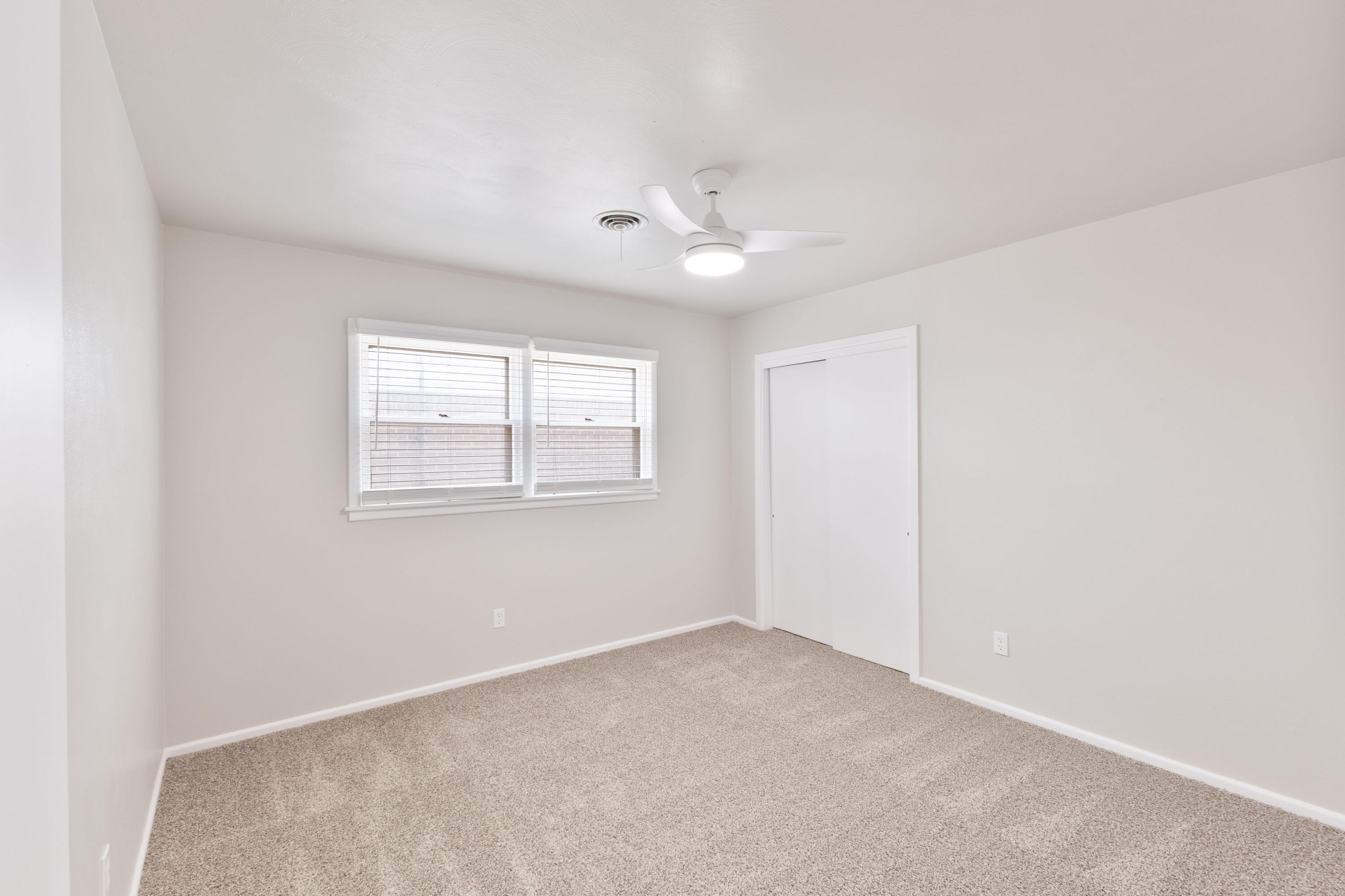 3417 52nd Street Lubbock, TX 79413 - Photo 15 of 19 an empty room with a window and a ceiling fan