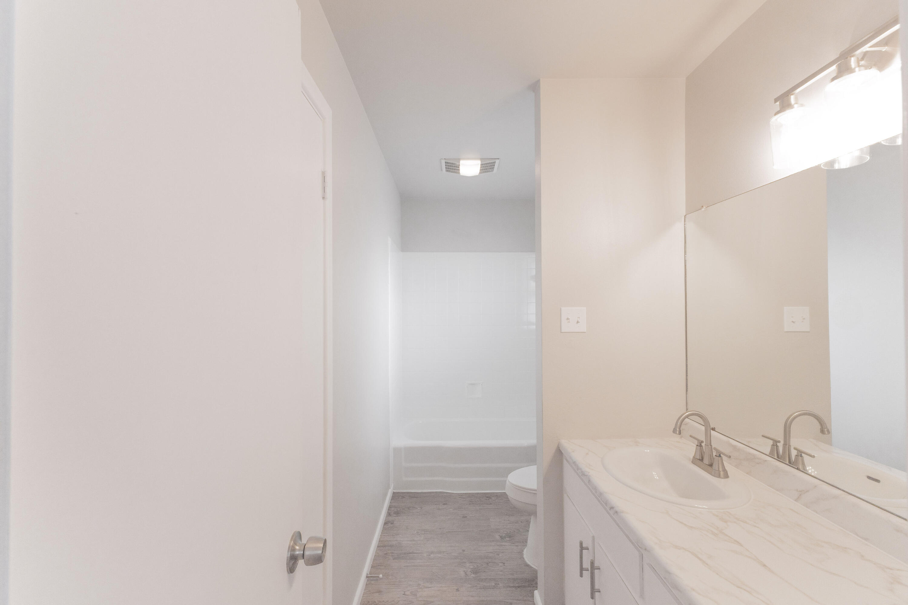 3417 52nd Street Lubbock, TX 79413 - Photo 17 of 19 a bathroom with a sink and a mirror