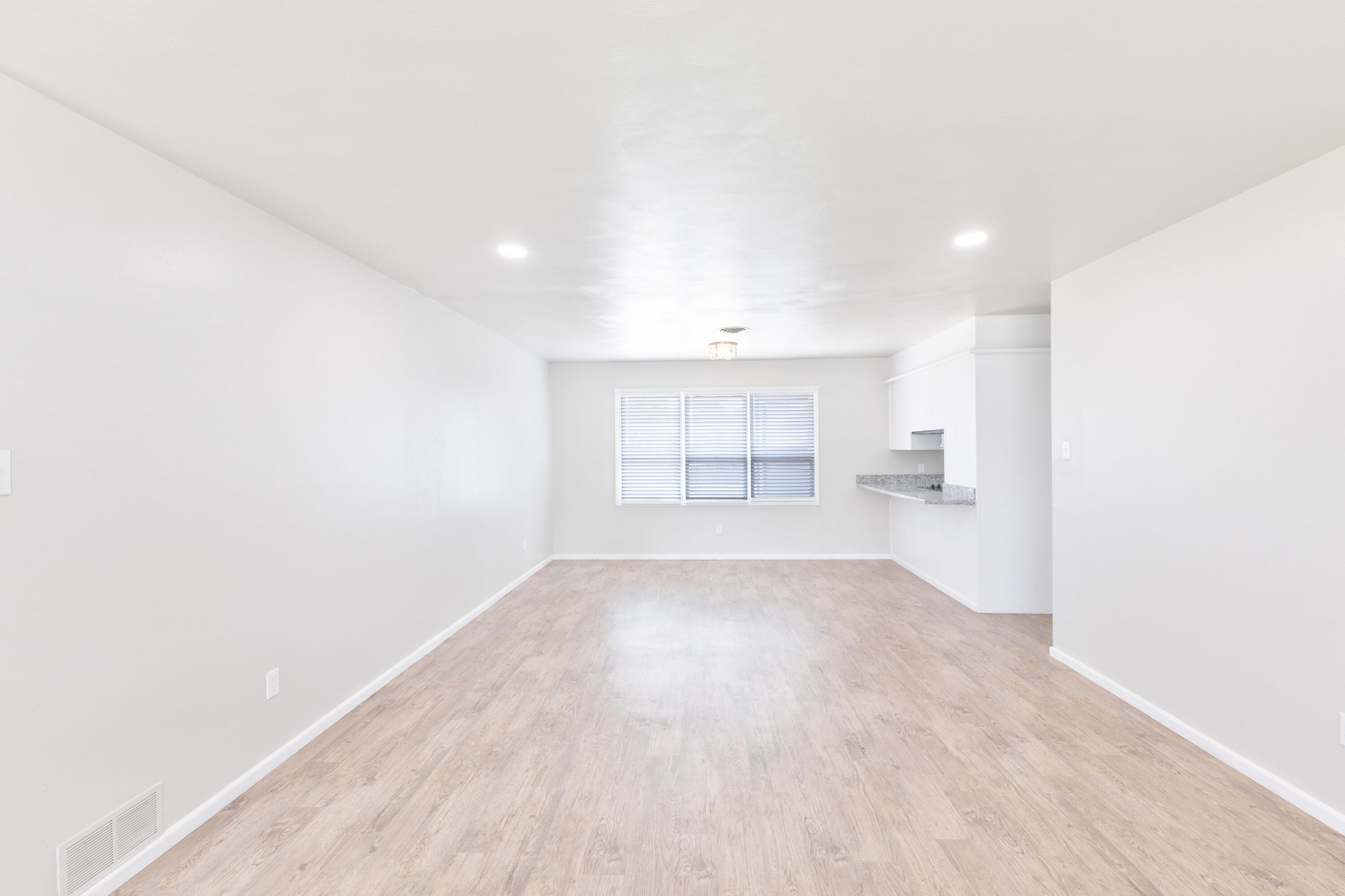 3417 52nd Street Lubbock, TX 79413 - Photo 2 of 19 a view of a room with wooden floor and windows