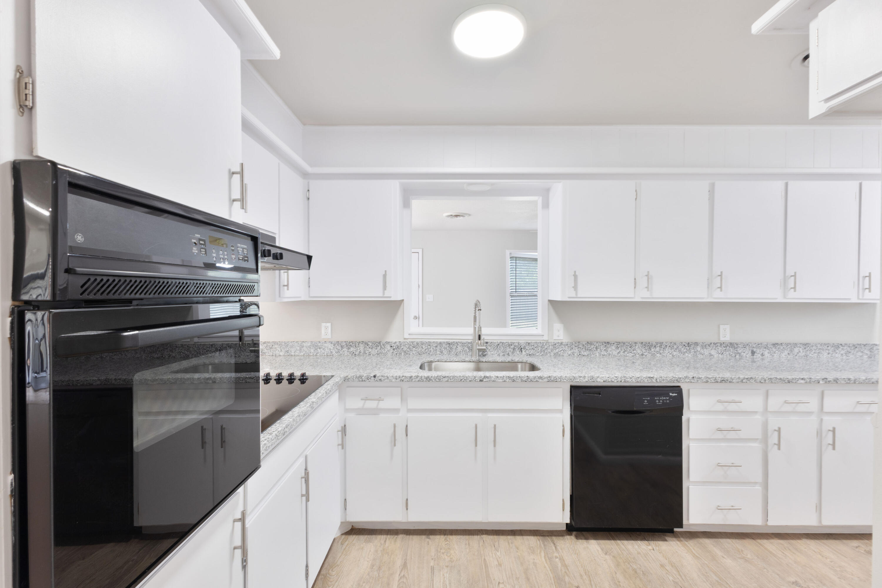 3417 52nd Street Lubbock, TX 79413 - Photo 7 of 19 a kitchen with a sink stove and cabinets