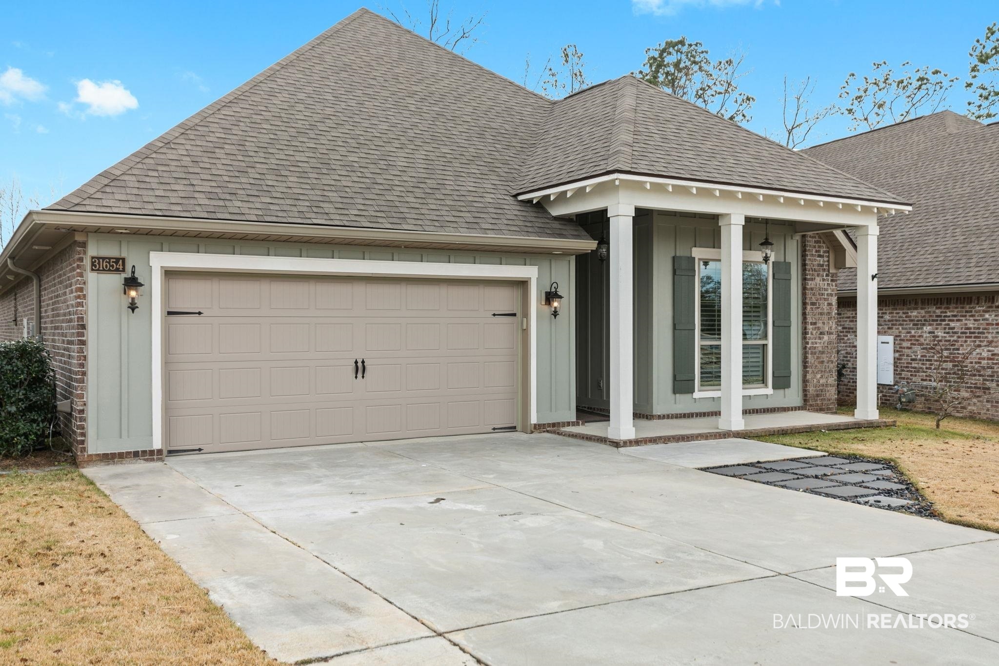 31654 Canopy Loop Daphne, AL 36527 - Photo 6 of 64 View of front of house with brick siding, roof with shingles, an attached garage, concrete driveway, and board and batten siding