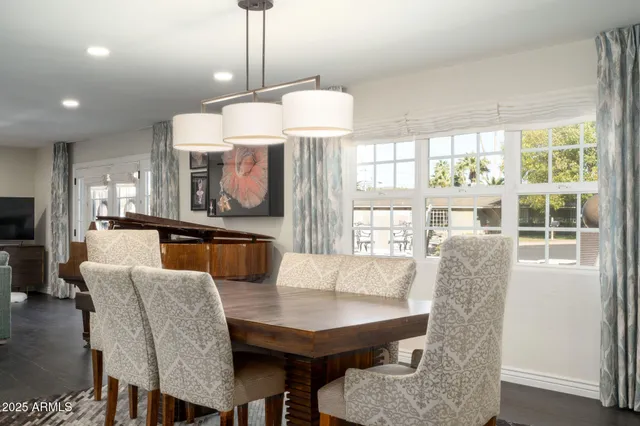 a dining room with furniture a chandelier and window