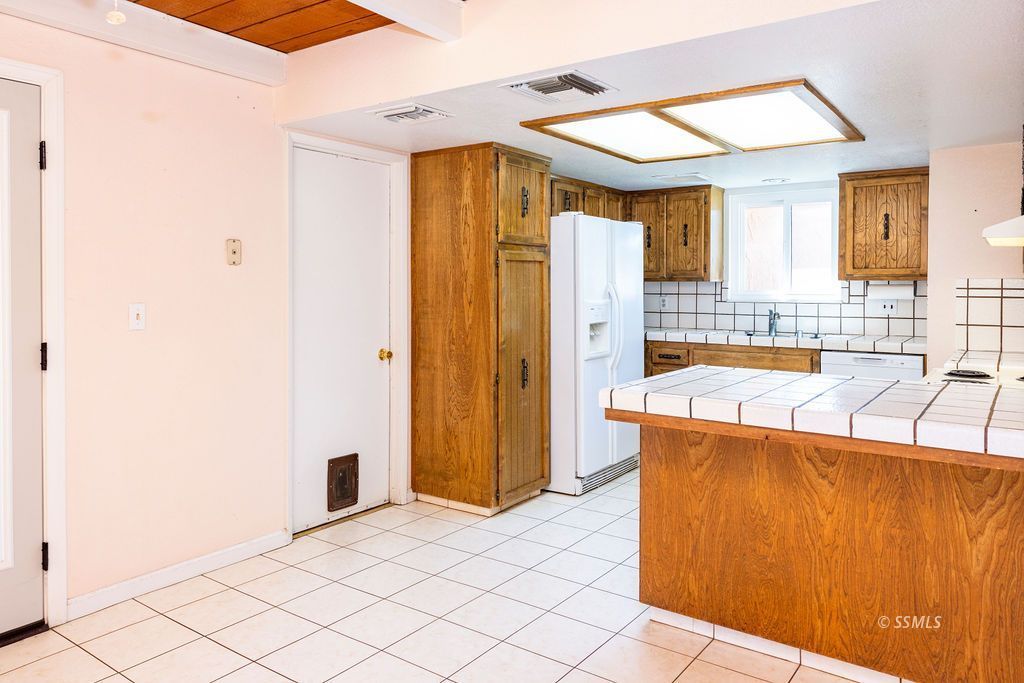 1144 West Benson Avenue Ridgecrest, CA 93555 - Photo 14 of 32 a bathroom with a sink a bathtub and a shower