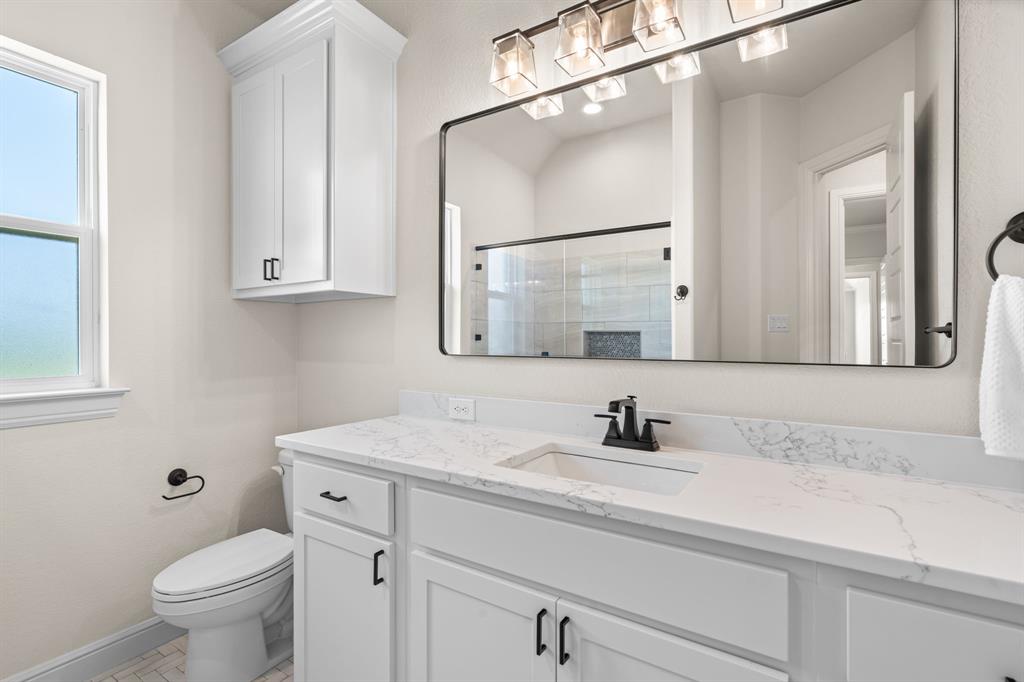 161 Frontera Drive Decatur, TX 76234 - Photo 26 of 39 Guest Bathroom with Walk-In Shower, Storage Cabinetry & Decorative Hardware and Tile.