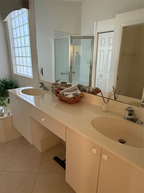 6710 Vía Roma Delray Beach, FL 33446 - Photo 16 of 35 a bathroom with a granite countertop sink and a mirror