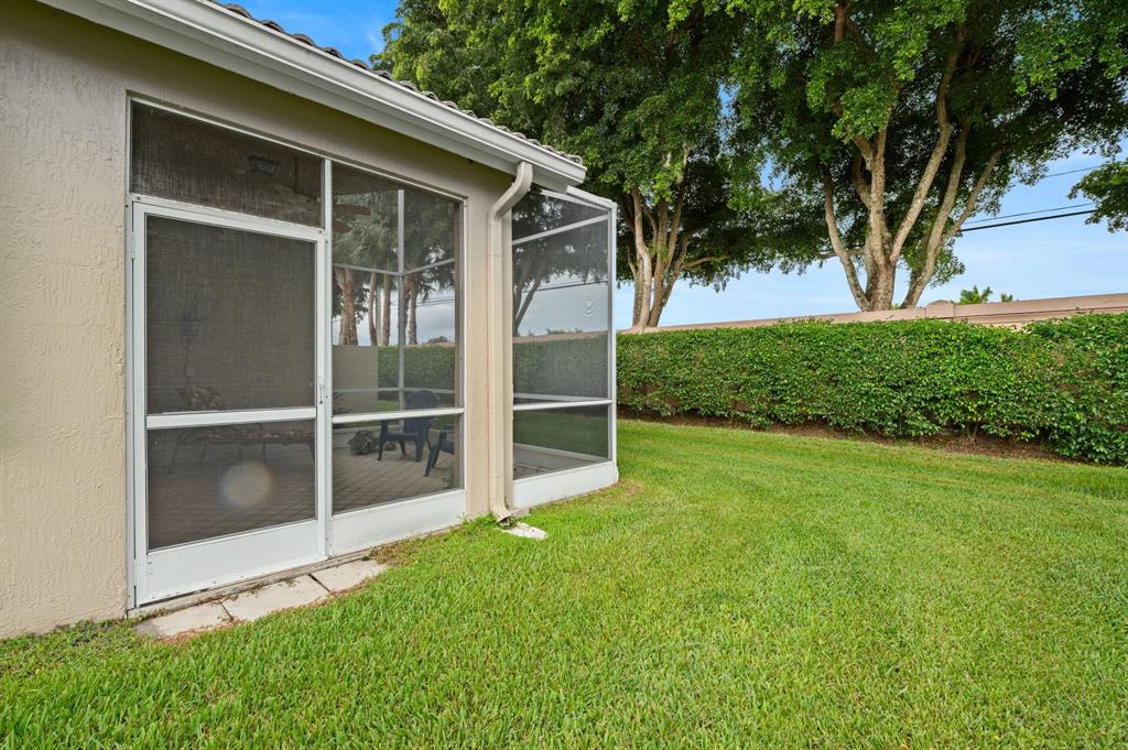 6710 Vía Roma Delray Beach, FL 33446 - Photo 22 of 35 a view of an house with backyard space and a lake view
