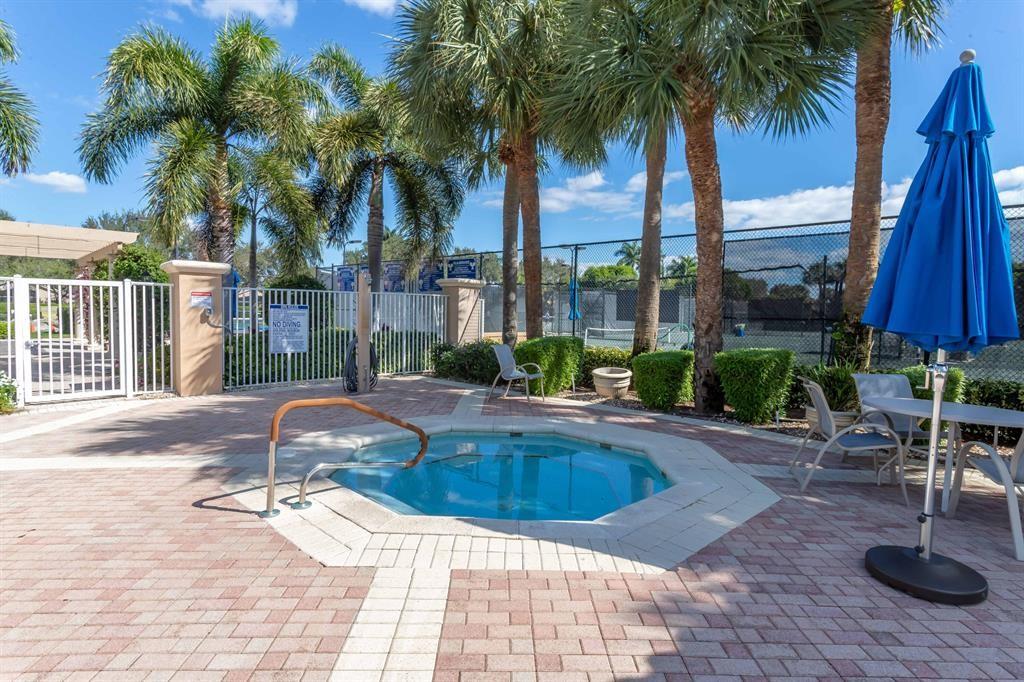 6710 Vía Roma Delray Beach, FL 33446 - Photo 27 of 35 a swimming pool with outdoor seating and yard