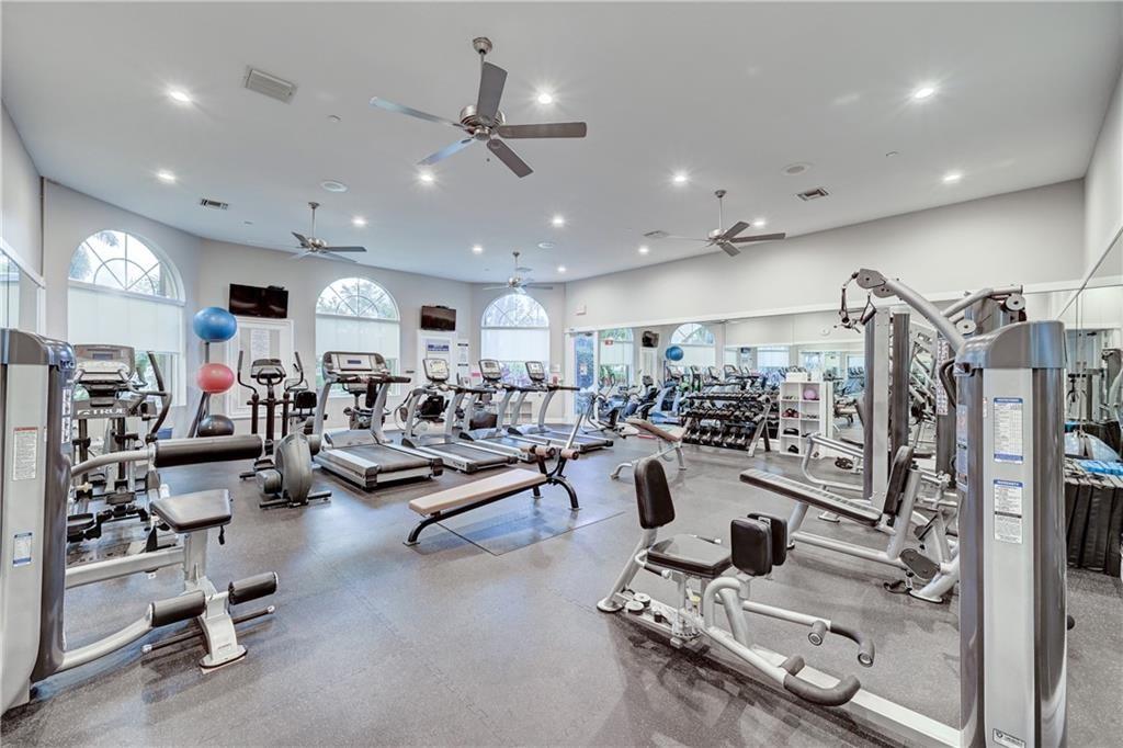 6710 Vía Roma Delray Beach, FL 33446 - Photo 32 of 35 a view of a room with gym equipment and a large window