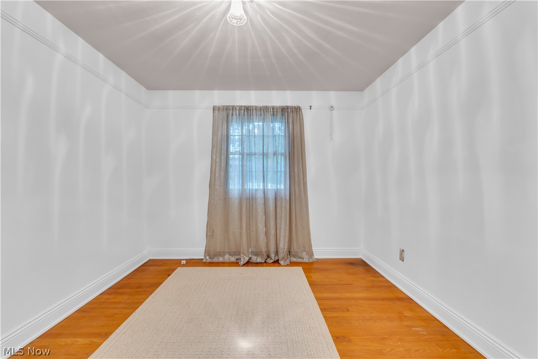 9897 West Ridge Road Elyria, OH 44035 - Photo 19 of 43 Unfurnished room featuring wood-type flooring