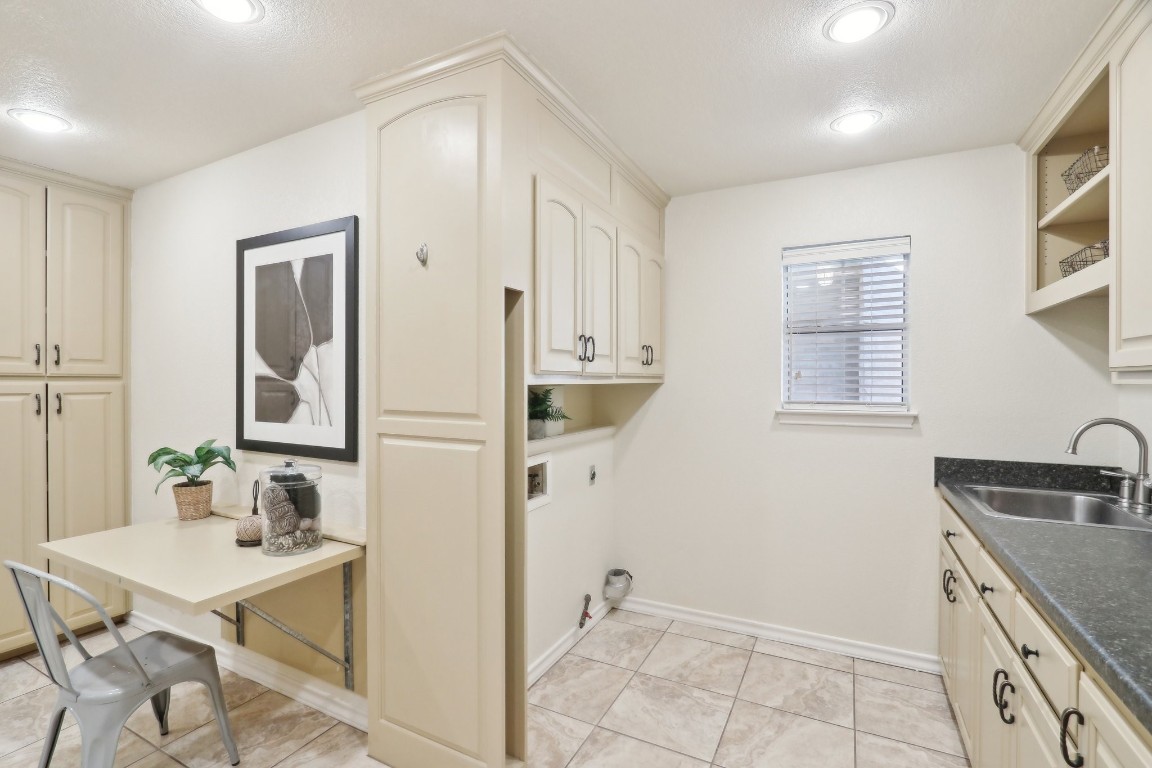 294 Logan Ranch Road Georgetown, TX 78628 - Photo 17 of 40 a kitchen with stainless steel appliances granite countertop a sink and a refrigerator