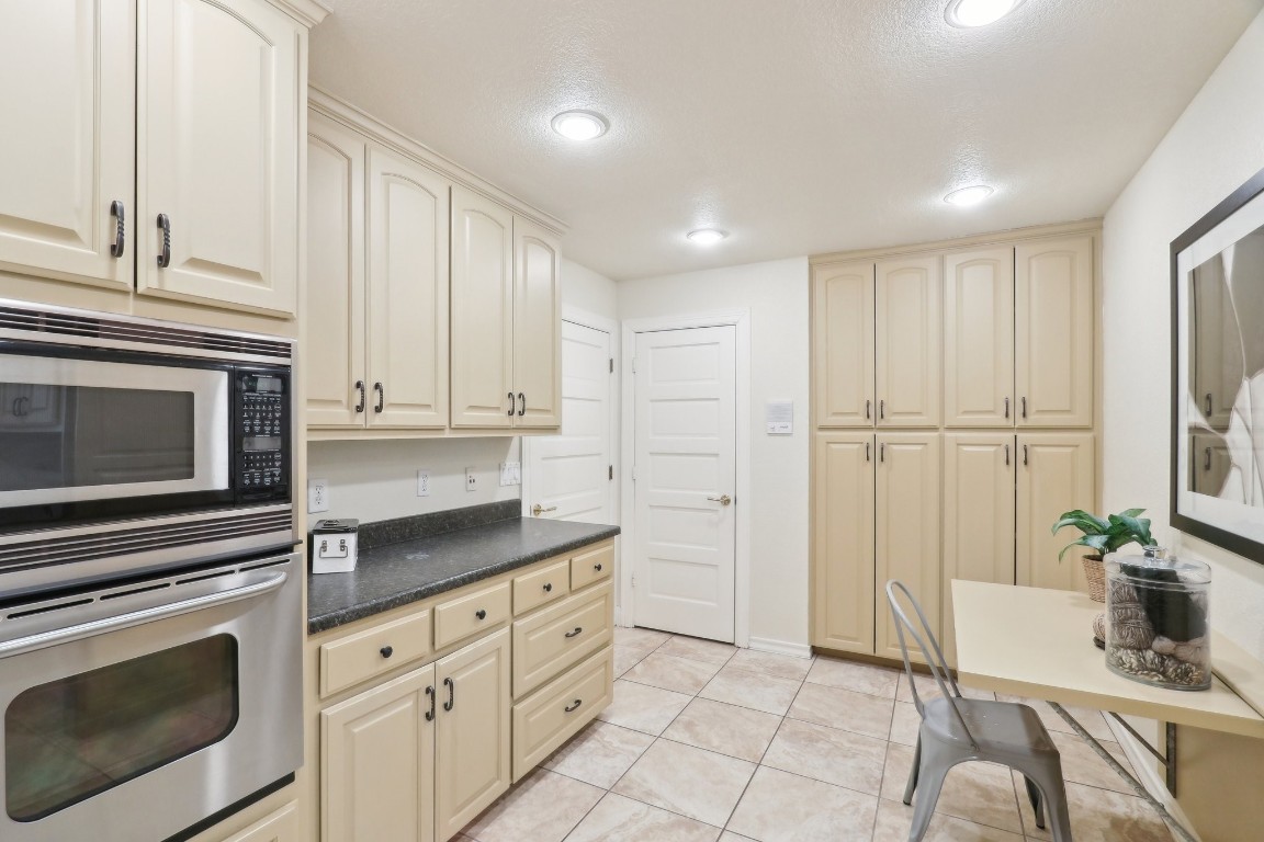 294 Logan Ranch Road Georgetown, TX 78628 - Photo 18 of 40 a kitchen with granite countertop white cabinets and stainless steel appliances
