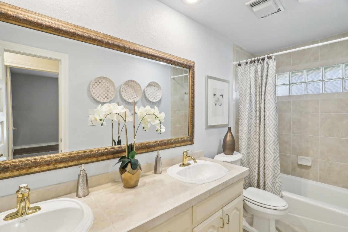 294 Logan Ranch Road Georgetown, TX 78628 - Photo 29 of 40 a bathroom with a sink a toilet and shower