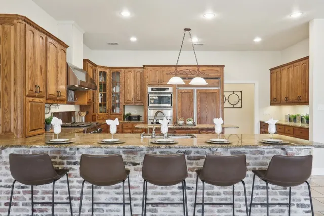 a large kitchen with a table and chairs