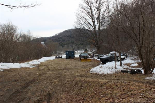 91 Foundry Village Road Colrain, MA 01340 - Photo 7 of 10 a view of a fire pit with large trees