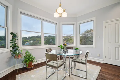 a dining room with furniture window and wooden floor