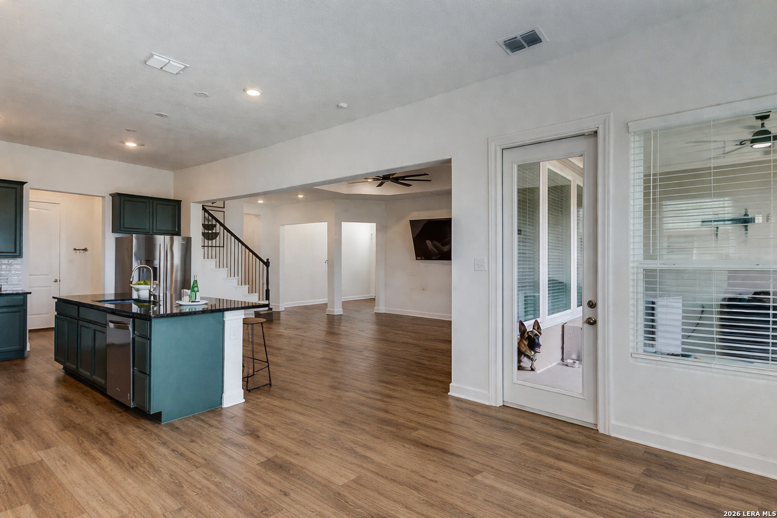 390 Rhapsody View Spring Branch, TX 78070 - Photo 12 of 28 a view of a living room and kitchen with furniture and wooden floor