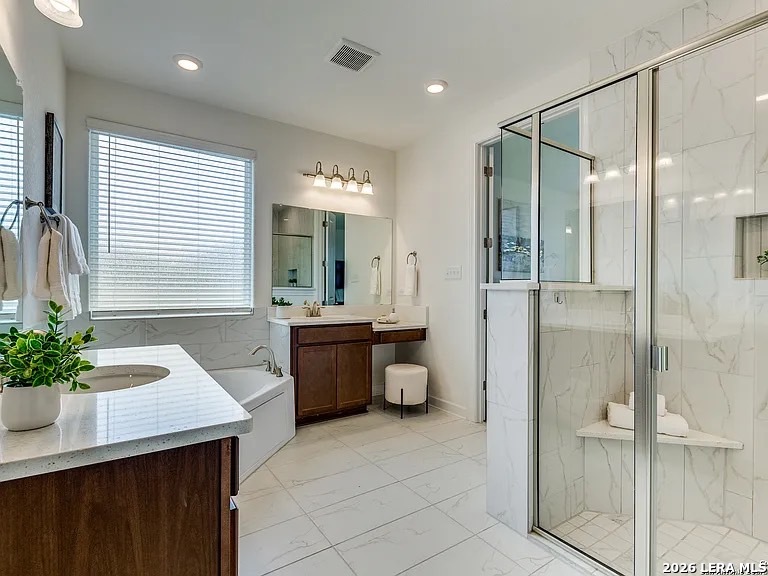 390 Rhapsody View Spring Branch, TX 78070 - Photo 20 of 28 a bathroom with a double vanity sink a large mirror and a shower