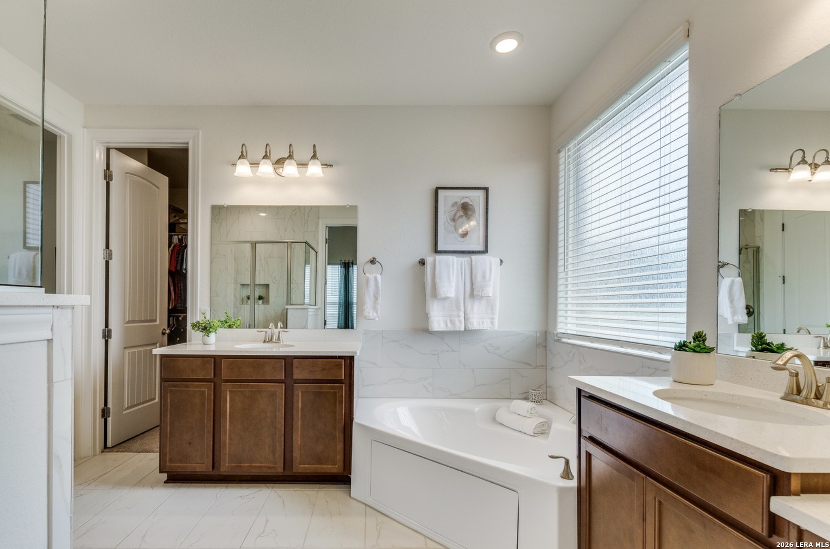 390 Rhapsody View Spring Branch, TX 78070 - Photo 21 of 28 a bathroom with a sink double vanity granite tub shower and a mirror