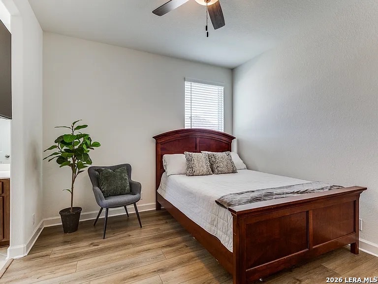 390 Rhapsody View Spring Branch, TX 78070 - Photo 22 of 28 a bedroom with a bed and a chair