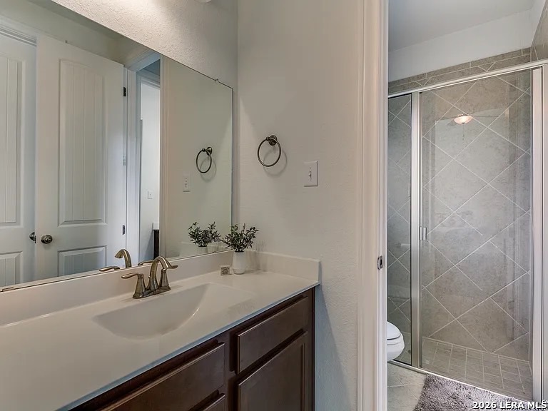 390 Rhapsody View Spring Branch, TX 78070 - Photo 23 of 28 a bathroom with a sink and a mirror
