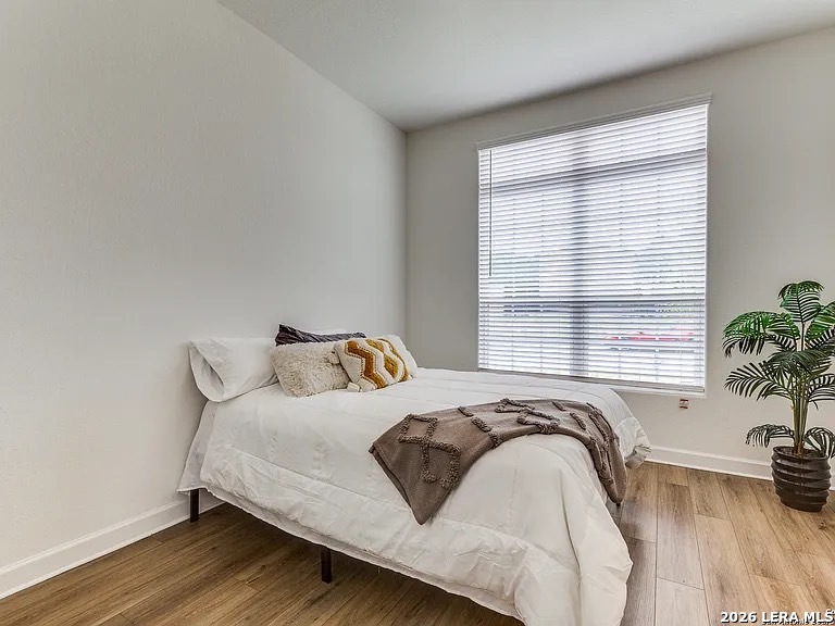 390 Rhapsody View Spring Branch, TX 78070 - Photo 25 of 28 a bedroom with a bed and with potted plant next to a window