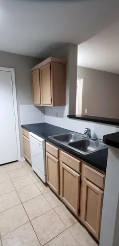 a kitchen with granite countertop a sink and a stove