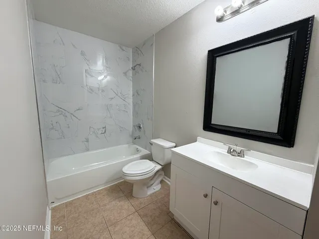 a bathroom with a sink toilet a mirror a bathtub and shower