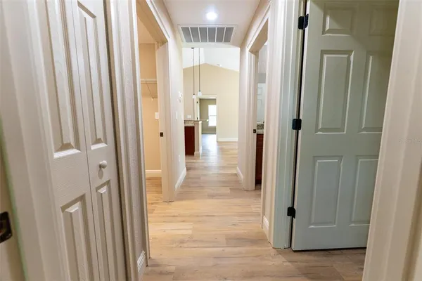 a view of empty room with wooden floor